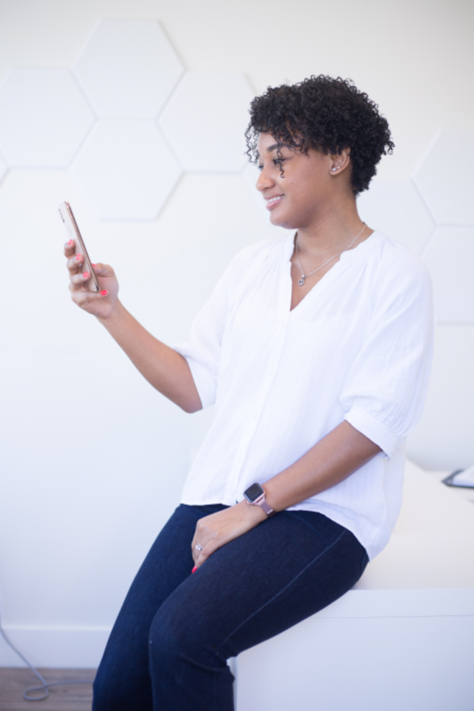 Woman checking her phone in a bright office