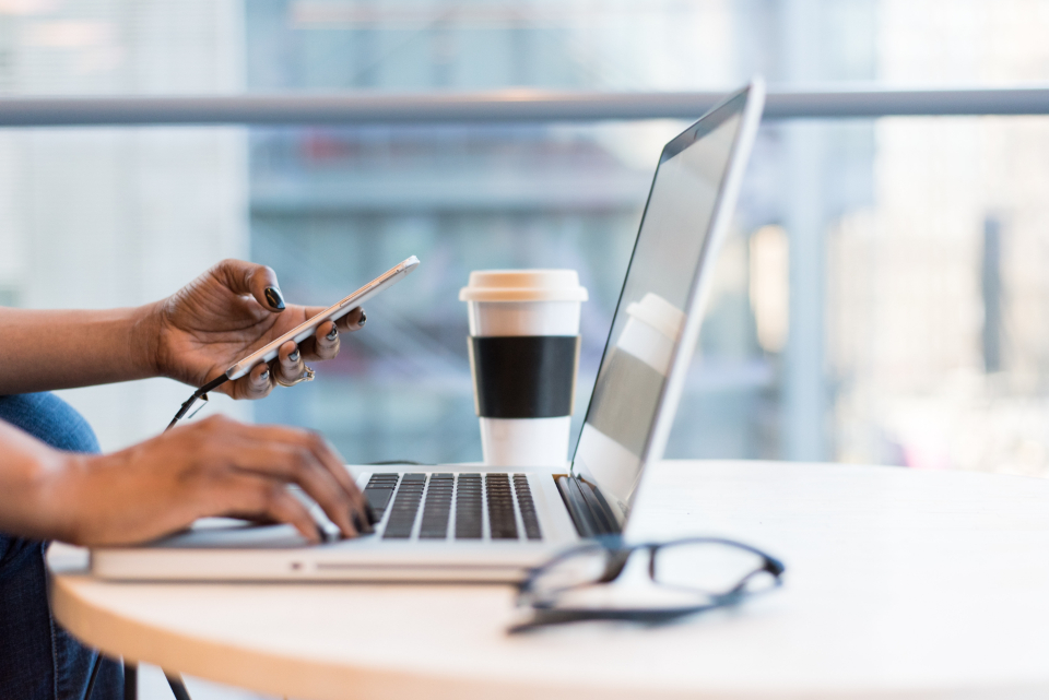 Laptop and phone on a cafe table